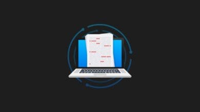 a laptop with papers on it